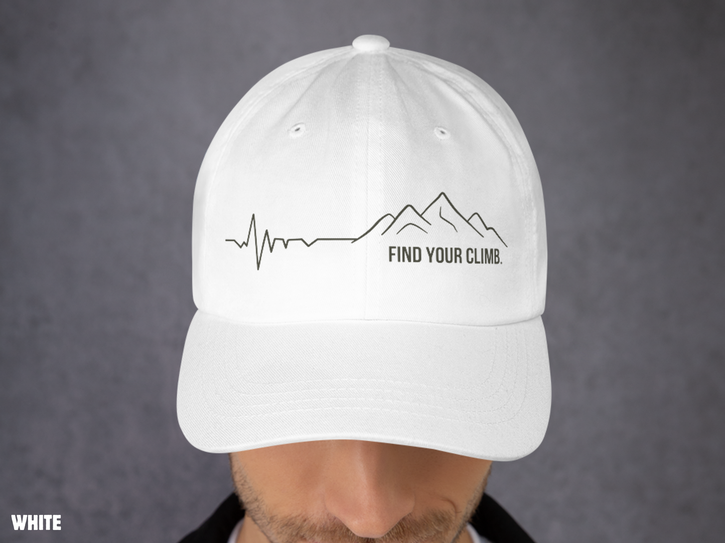 A white baseball cap with a black mountain line graphic and the text 'FIND YOUR CLIMB.' on the front, shown worn by a person against a gray background.